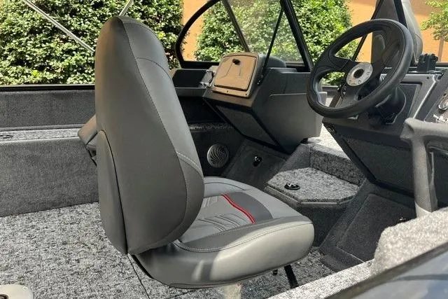 Slide: The Image of 2026 Tracker Pro Guide V-175 WT boat interior with steering wheel and seating. - 4