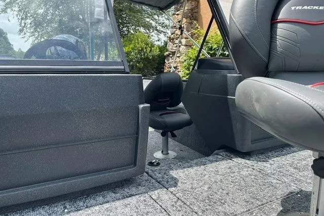 Slide: The Image of 2026 Tracker Pro Guide V-175 WT boat interior with gray seating and carpeted flooring. - 6