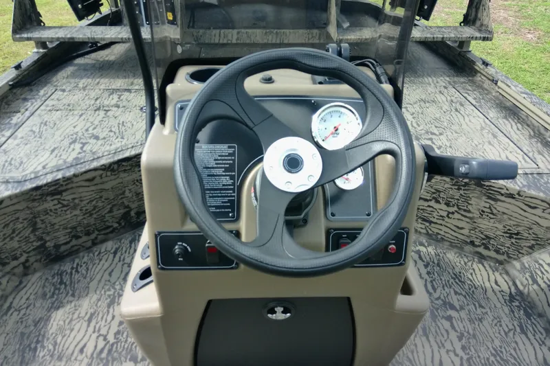 Slide: The Image of Steering console of 2026 Tracker Grizzly 2072 CC Sportsman boat with camo design. - 90
