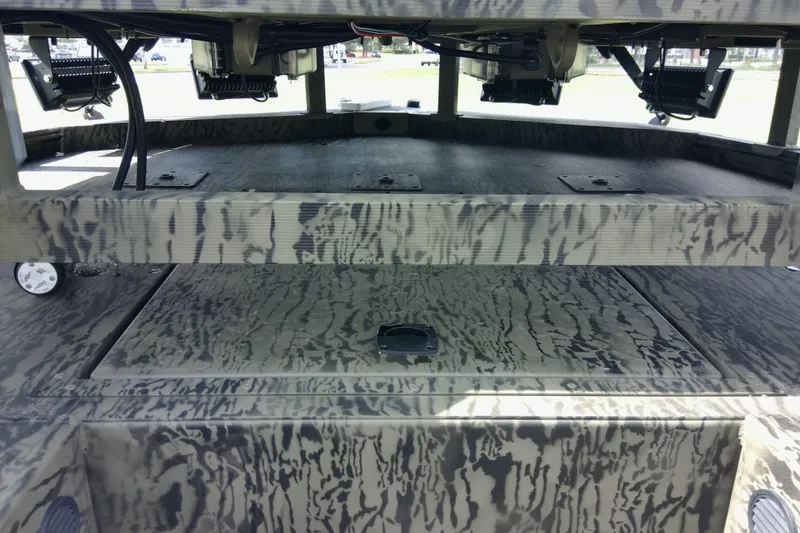 Slide: The Image of 2026 Tracker Grizzly 2072 CC Sportsman boat interior with camouflage pattern and equipment. - 88