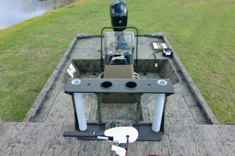 Slide: The Image of 2026 Tracker Grizzly 2072 CC Sportsman boat interior with fishing rod holders. - 86
