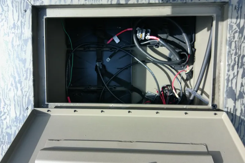 Slide: The Image of Open compartment of 2026 Tracker Grizzly 2072 CC Sportsman showing wiring and components. - 89