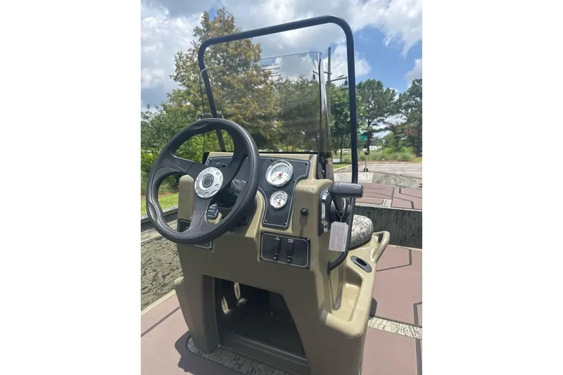 Slide: The Image of 2026 Tracker Grizzly 1860 CC boat console with steering wheel and gauges. - 7