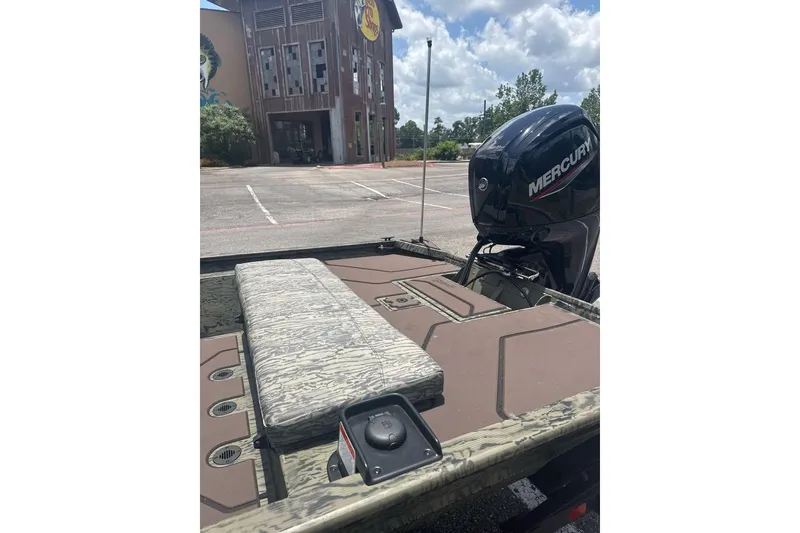 Slide: The Image of 2026 Tracker Grizzly 1860 CC boat with Mercury engine in parking lot. - 6