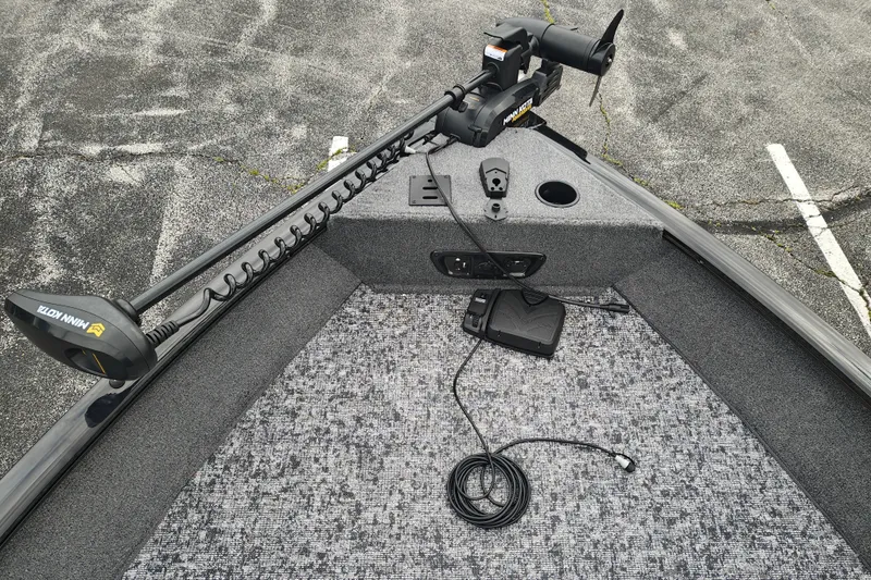 Slide: The Image of 2026 Tracker Pro Guide V-175 WT boat with Minn Kota trolling motor on carpeted deck. - 12
