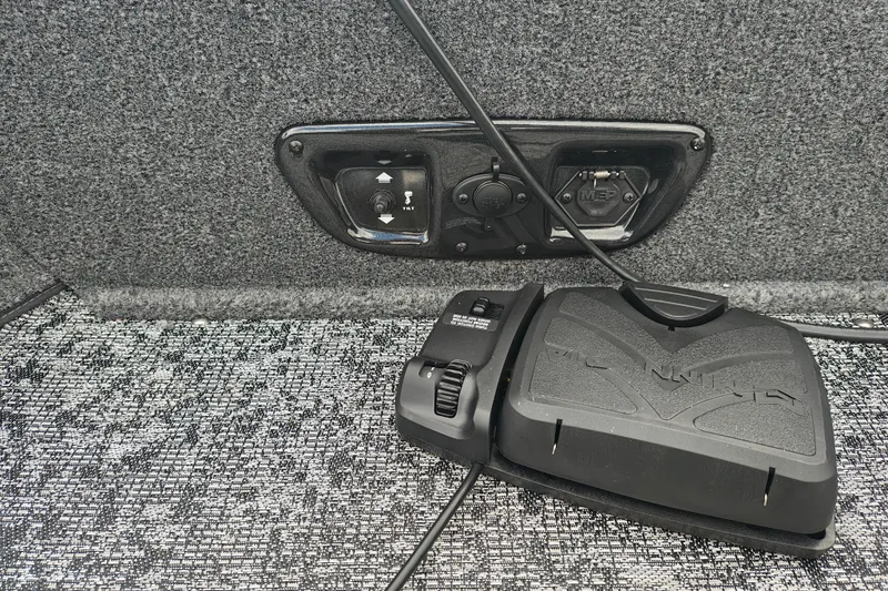 Slide: The Image of 2026 Tracker Pro Guide V-175 WT boat control panel with foot pedal on carpeted floor. - 13