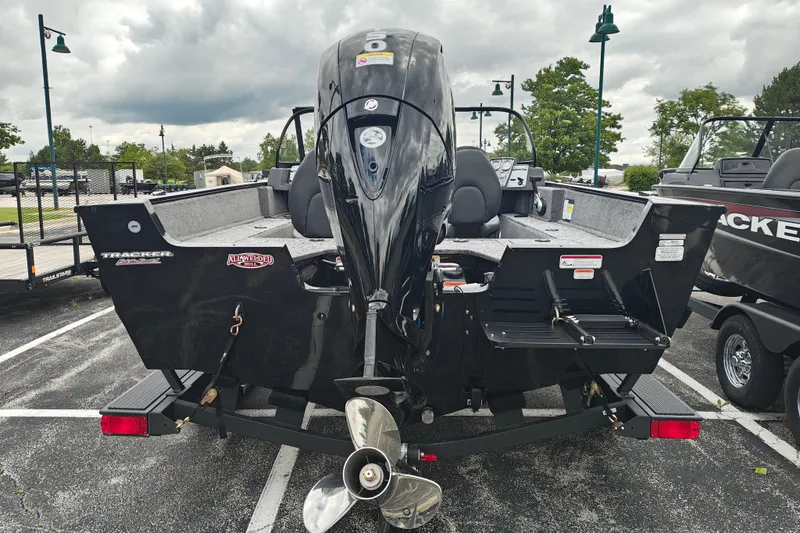 Slide: The Image of 2026 Tracker Pro Guide V-175 WT boat with powerful outboard motor in parking lot. - 3