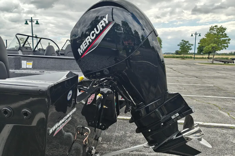 Slide: The Image of 2026 Tracker Pro Guide V-175 WT boat with Mercury outboard motor in a parking lot. - 4
