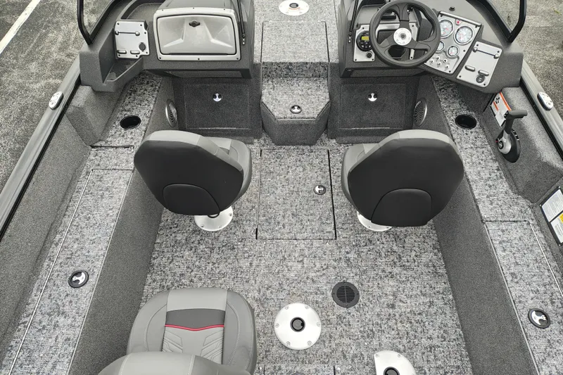 Slide: The Image of 2026 Tracker Pro Guide V-175 WT boat interior with gray seating and dashboard controls. - 7