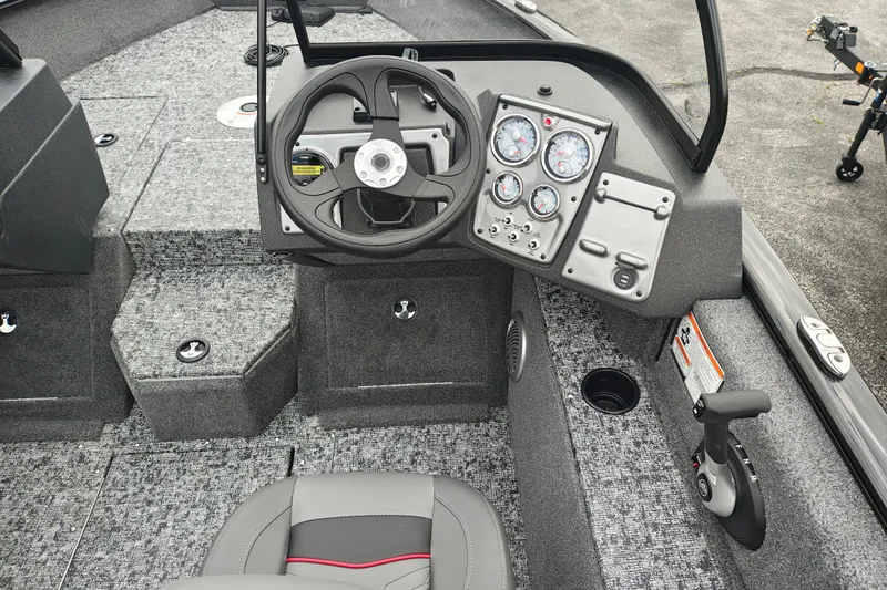 Slide: The Image of 2026 Tracker Pro Guide V-175 WT boat interior with steering wheel and control panel. - 9