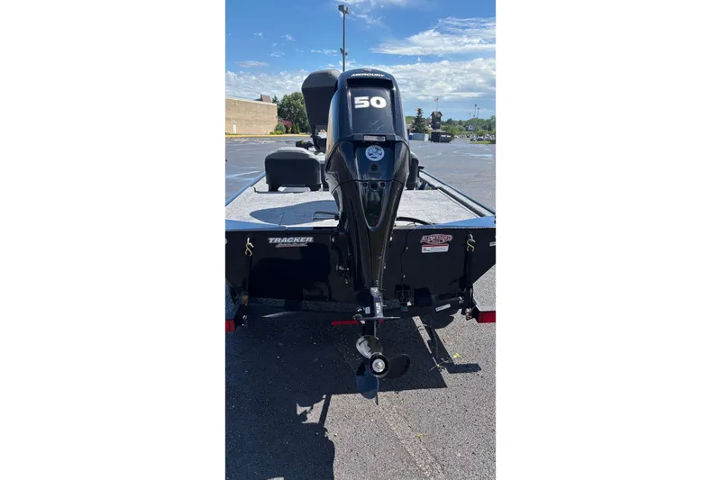 Slide: The Image of 2026 Tracker Bass Tracker Classic XL boat with Mercury 50 engine in a parking lot. - 2