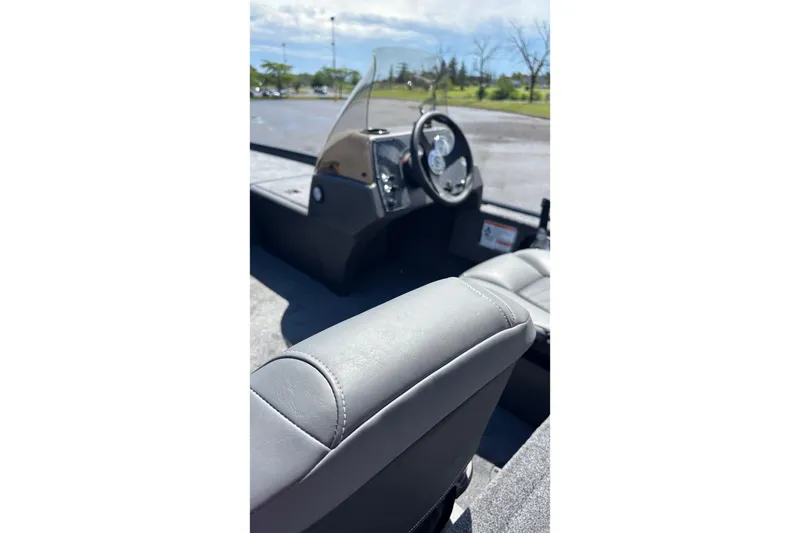 Slide: The Image of 2026 Tracker Bass Tracker Classic XL boat interior with steering wheel and seating. - 4