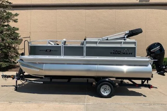 The Image of 2026 Sun Tracker Bass Buggy 16 XL Select pontoon boat on trailer, side view. - 0