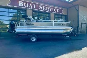The Image of 2026 Sun Tracker Bass Buggy 18 DLX pontoon boat at a boat service center. - 0