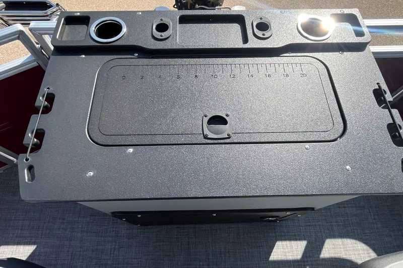 Slide: The Image of 2026 Sun Tracker SportFish 20 DLX fishing station with integrated measuring board and cup holders. - 19