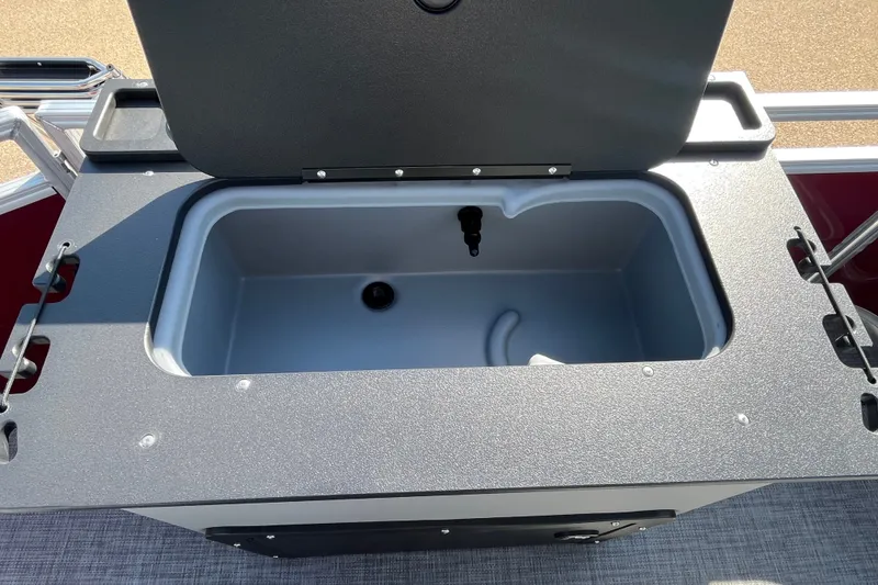 Slide: The Image of Open storage compartment on 2026 Sun Tracker SportFish 20 DLX boat. - 20