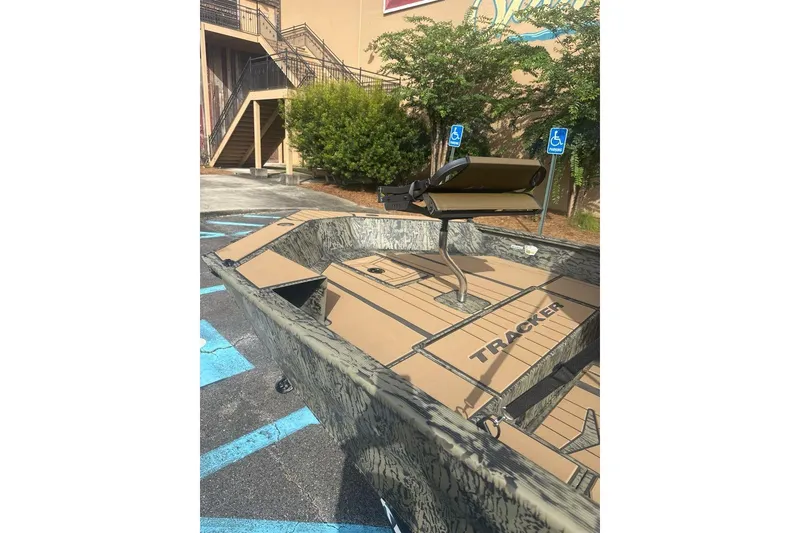 Slide: The Image of 2026 Tracker Grizzly 1756 T Marsh boat in parking lot, showcasing interior design. - 5