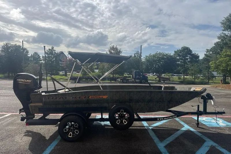 Slide: The Image of 2026 Tracker Grizzly 1756 T Marsh boat on trailer in parking lot. - 3