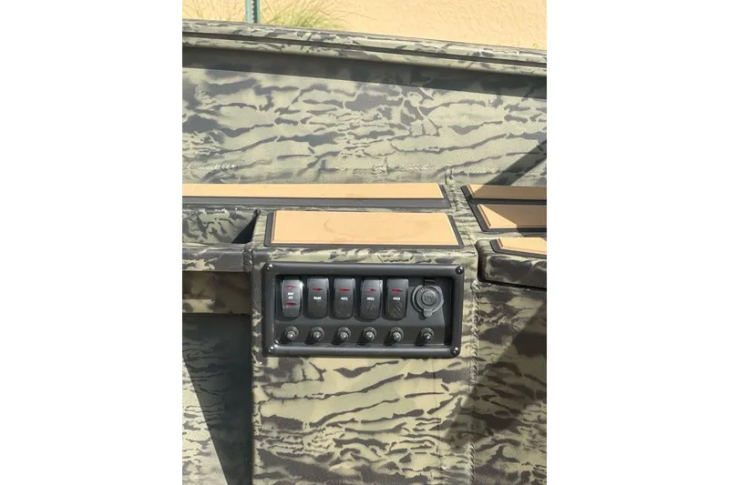 Slide: The Image of Control panel of 2026 Tracker Grizzly 1756 T Marsh boat with camouflage design. - 8
