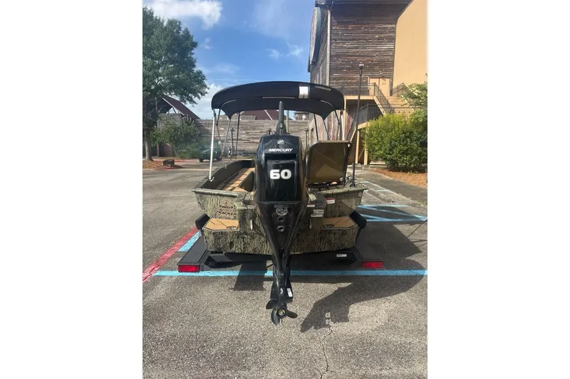 Slide: The Image of 2026 Tracker Grizzly 1756 T Marsh boat with Mercury 60 engine in parking lot. - 2