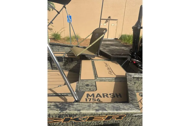 Slide: The Image of 2026 Tracker Grizzly 1756 T Marsh boat with camouflage design and seating. - 7