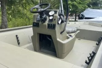 Slide: The Image of 2026 Tracker Grizzly 1860 CC boat interior with steering console and gauges. - 4
