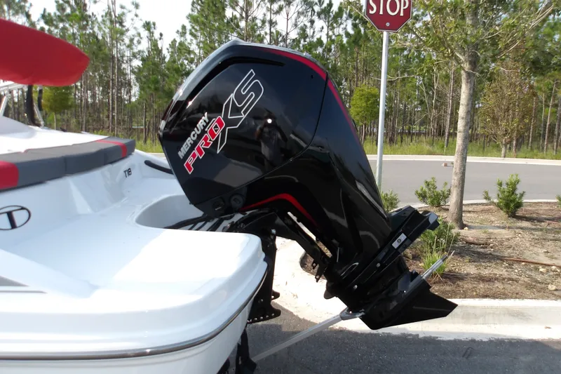 Slide: The Image of 2026 Tahoe T18 boat with Mercury Pro XS outboard motor in a wooded area. - 13
