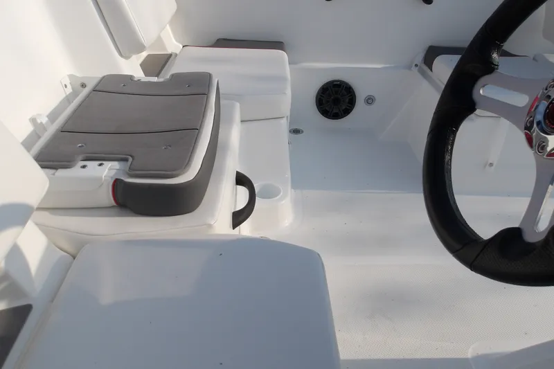 Slide: The Image of Interior of 2026 Tahoe T18 boat featuring seating and steering wheel. - 15