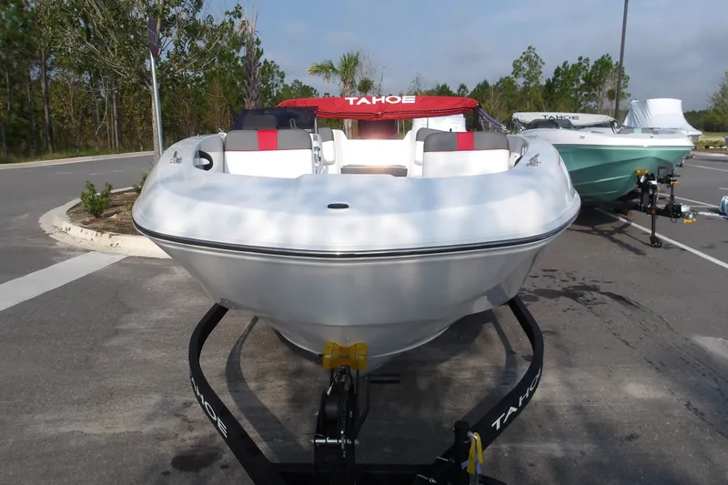 Slide: The Image of 2026 Tahoe T18 boat on trailer, parked outdoors, featuring sleek design and red accents. - 3