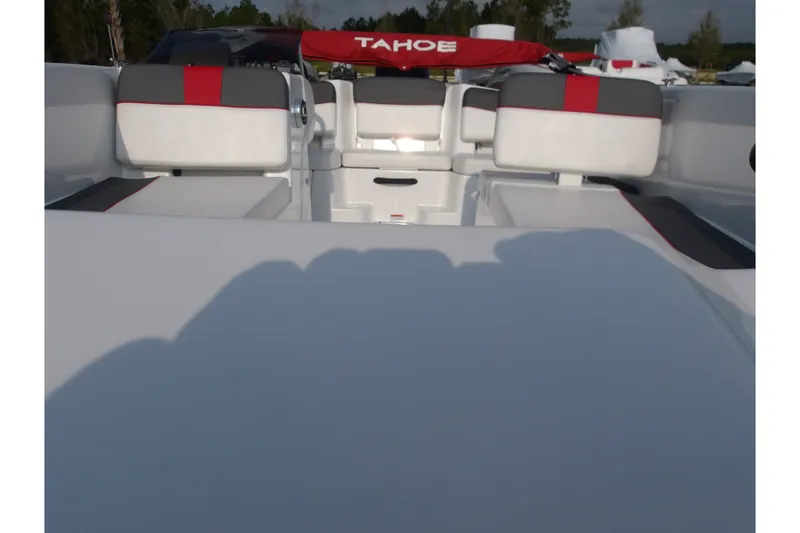 Slide: The Image of 2026 Tahoe T18 boat interior with red and gray seating, outdoor setting. - 27
