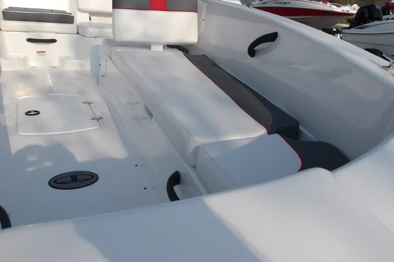 Slide: The Image of 2026 Tahoe T18 boat interior with white and gray seating, red accents, and storage compartments. - 16