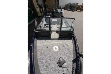 Slide: The Image of 2026 Tracker Pro Guide V-16 WT boat interior with steering console and seating. - 3