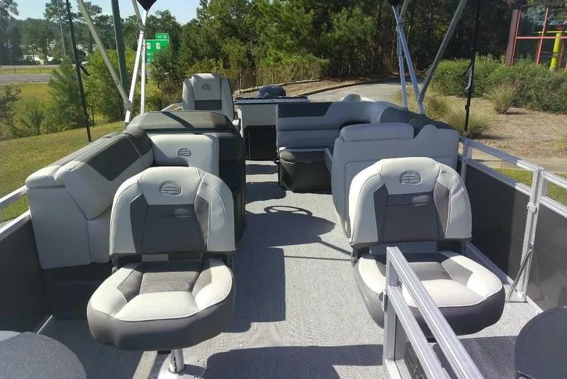 Slide: The Image of 2026 Sun Tracker Fishin' Barge 20 DLX interior with comfortable seating and spacious layout. - 5