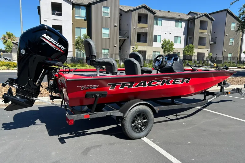 Slide: The Image of 2026 Tracker Pro Team 175 Crappie Edition boat with Mercury engine in parking lot. - 2