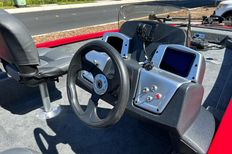 Slide: The Image of 2026 Tracker Pro Team 175 Crappie Edition boat interior with steering wheel and control panel. - 6