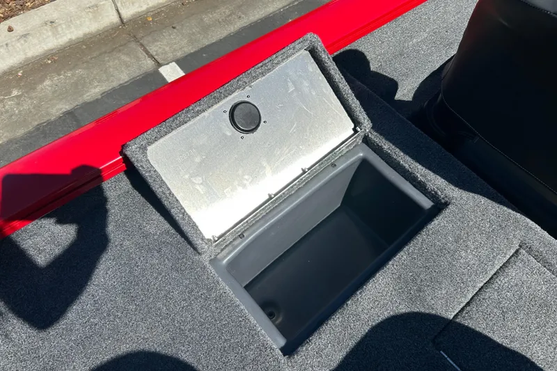 Slide: The Image of Open storage compartment on 2026 Tracker Pro Team 175 Crappie Edition boat, gray carpet interior. - 8