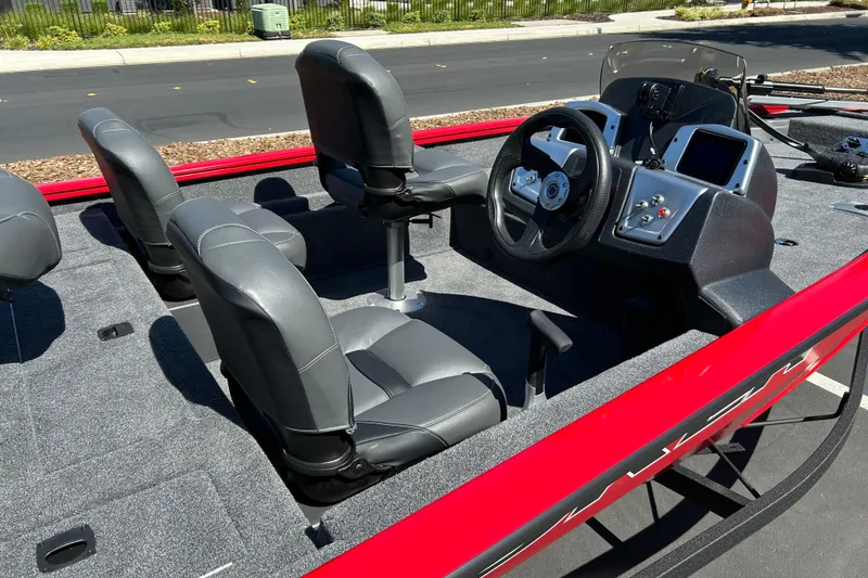 Slide: The Image of 2026 Tracker Pro Team 175 Crappie Edition boat interior with gray seats and steering console. - 5