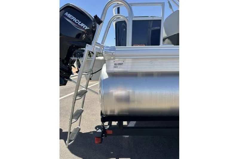 Slide: The Image of 2026 Sun Tracker Bass Buggy 18 DLX pontoon boat with Mercury outboard motor and ladder. - 99
