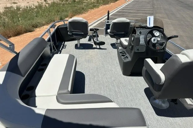 Slide: The Image of 2026 Sun Tracker Bass Buggy 18 DLX pontoon boat interior with seating and steering console. - 15