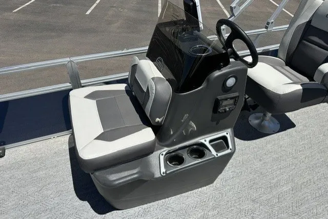 Slide: The Image of 2026 Sun Tracker Bass Buggy 18 DLX boat interior with steering console and seating. - 13