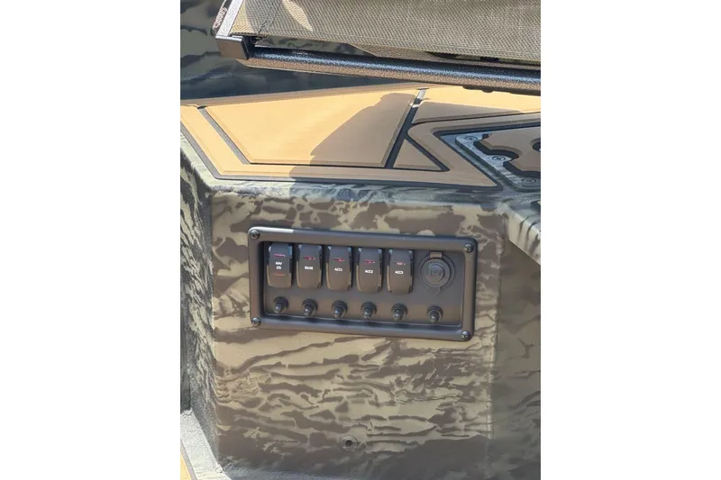 Slide: The Image of Control panel of 2026 Tracker Grizzly 1650 T Prairie Wings Edition boat, featuring camo design. - 7