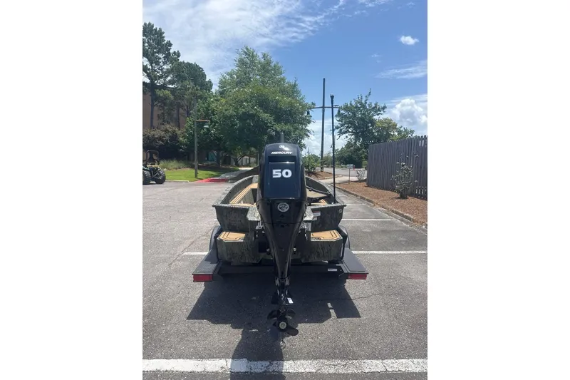 Slide: The Image of 2026 Tracker Grizzly 1650 T Prairie Wings Edition boat on trailer, rear view. - 2