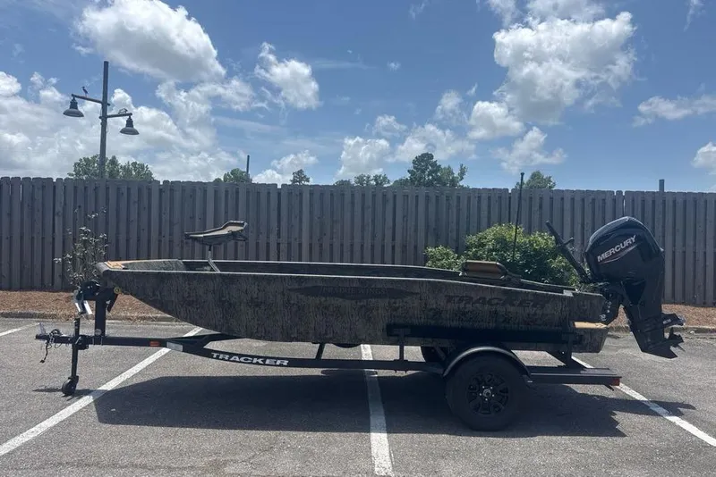 The Image of 2026 Tracker Grizzly 1650 T Prairie Wings Edition boat on trailer, parked outdoors. - 0