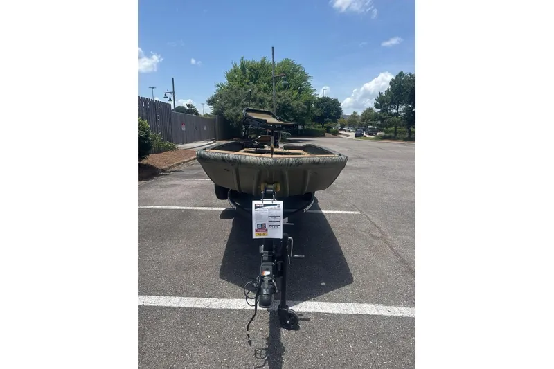 Slide: The Image of 2026 Tracker Grizzly 1650 T Prairie Wings Edition boat in parking lot, sunny day. - 6