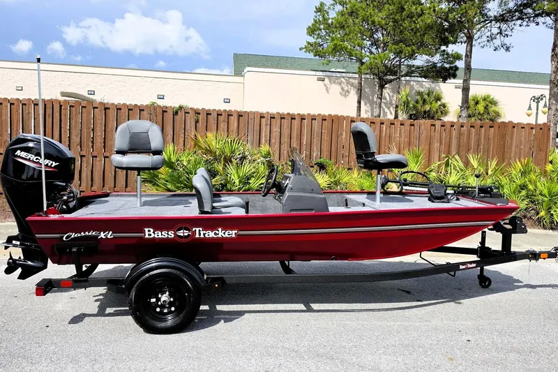 The Image of 2026 Tracker Bass Tracker Classic XL boat on trailer, red exterior, parked outdoors. - 0