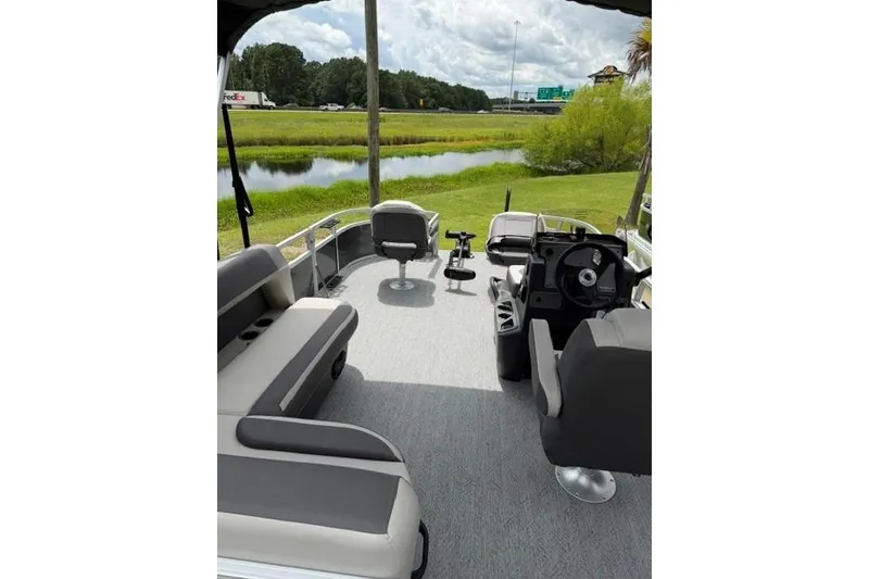 Slide: The Image of 2026 Sun Tracker Bass Buggy 16 XL Select interior with seating and steering console. - 14