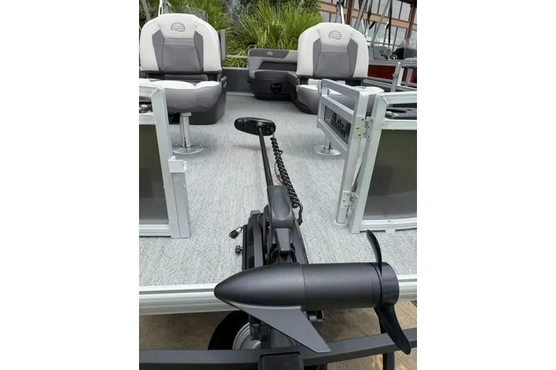 Slide: The Image of 2026 Sun Tracker Bass Buggy 16 XL Select pontoon boat interior with seating and motor. - 5