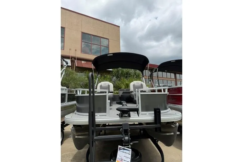 Slide: The Image of 2026 Sun Tracker Bass Buggy 16 XL Select pontoon boat displayed outdoors. - 17