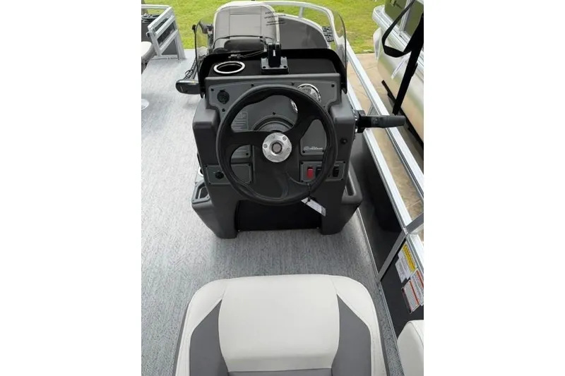 Slide: The Image of 2026 Sun Tracker Bass Buggy 16 XL Select steering console with modern controls and seating. - 10