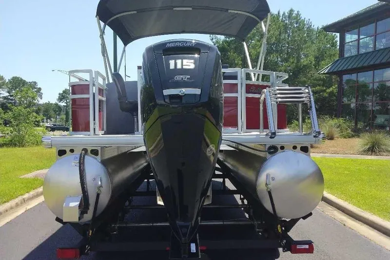 Slide: The Image of 2026 Sun Tracker SportFish 20 DLX pontoon boat with Mercury 115 GT engine, parked outdoors. - 3